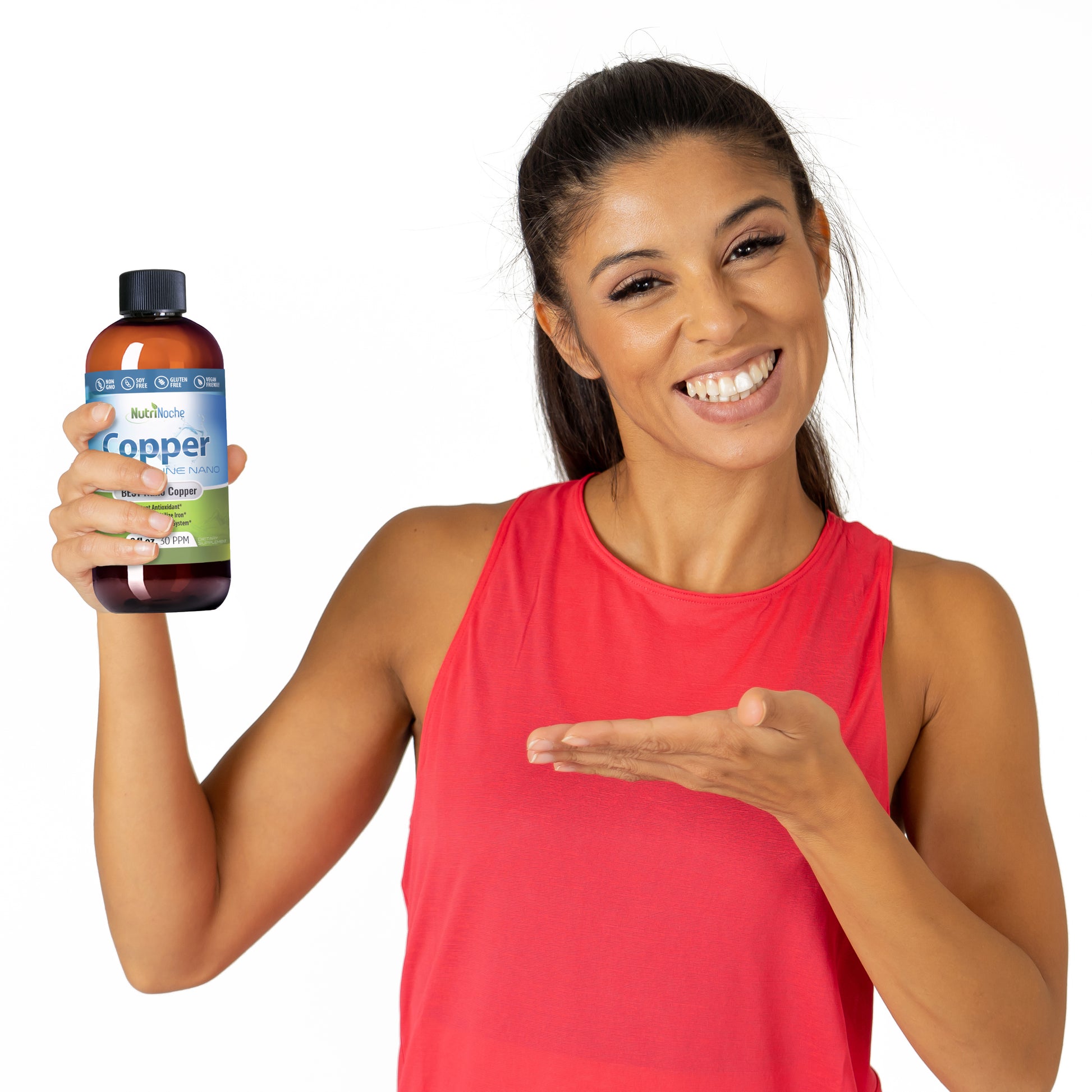 Woman holding a bottle of NutriCure Copper supplement against a white background
